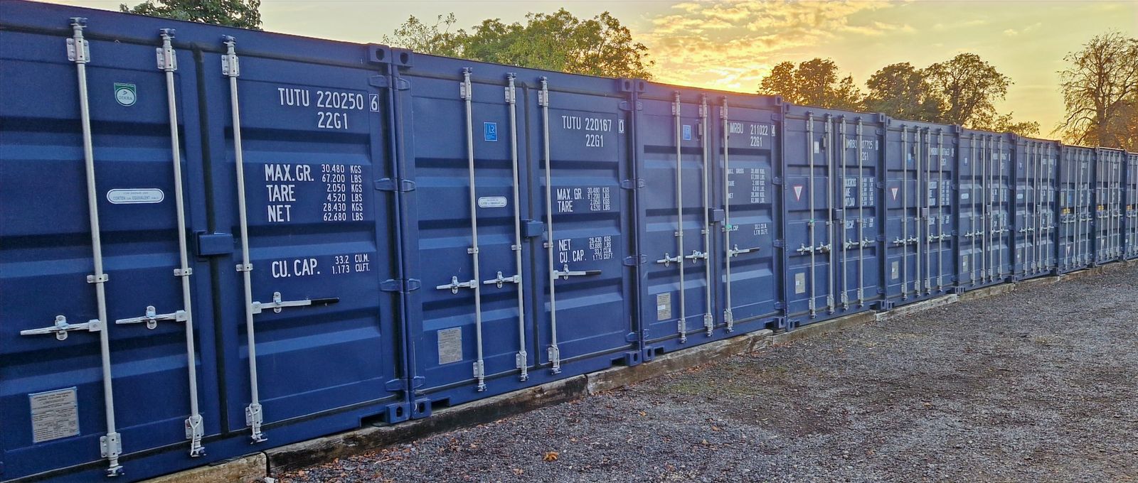Row of blue storage containers at the CamStorage yard in Bottisham